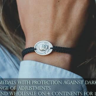 Padre Pio bracelet on wrist – black cord bracelet with oval Saint Padre Pio medal