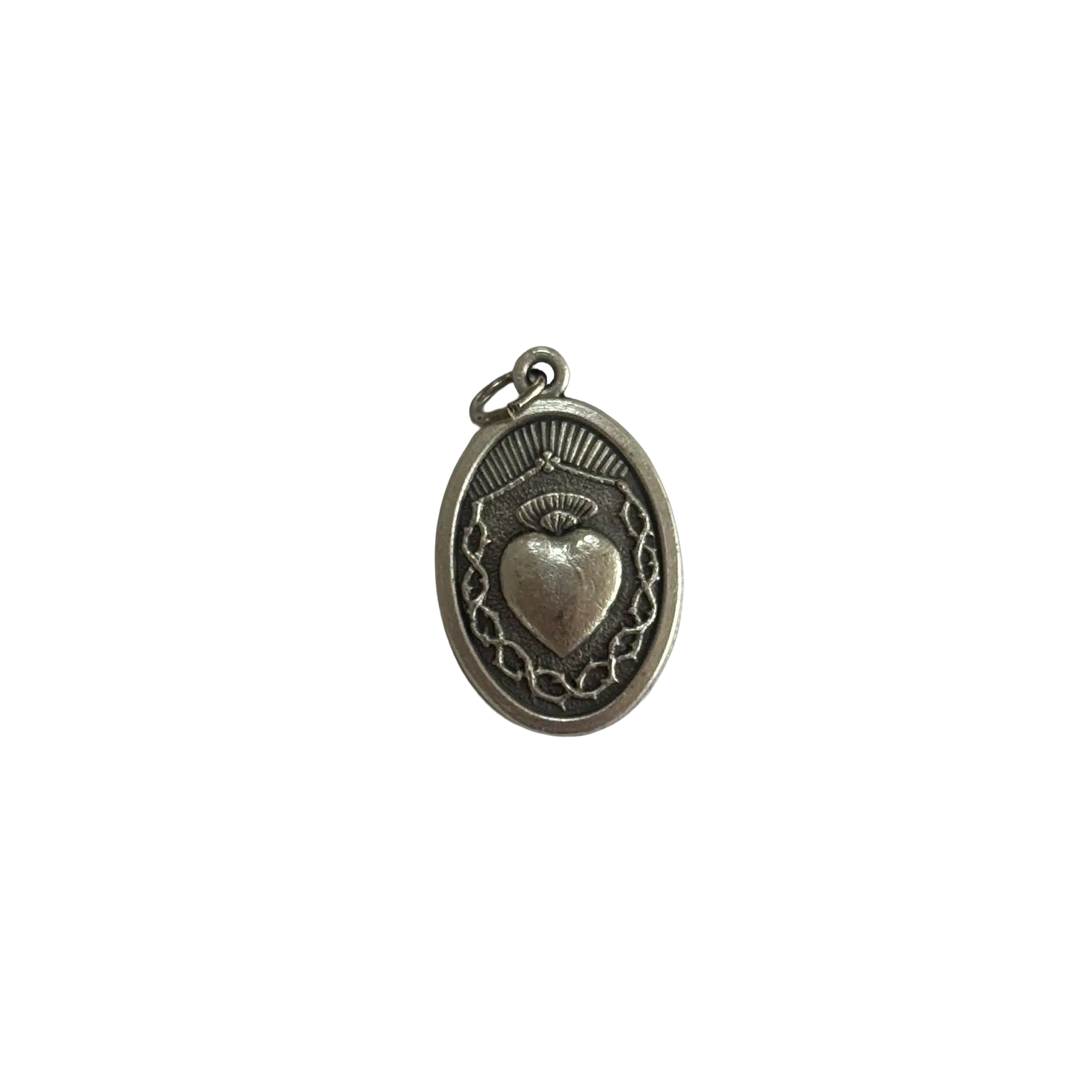 Reverse side of a silver St Alice medal featuring the Sacred Heart surrounded by a crown of thorns.